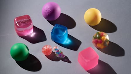 Shown: Nee-Doh Groovy Glob, ZaxiDeel Squishy Fidget Cube, Color Changing Magic Arggh Ball Minis, Yoya Toys DNA Balls, Visashine Mochi Squishy Toys, Everyday Whimtastic Handmade Ice Cube Stressball, Playbees Sensory Bounce Balls, Nee-Doh Nice Cube